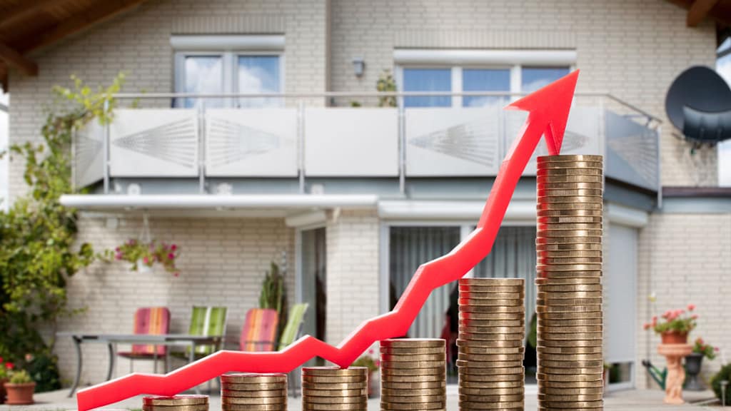 Home selling checklist and pricing strategy with model house and stacked coins