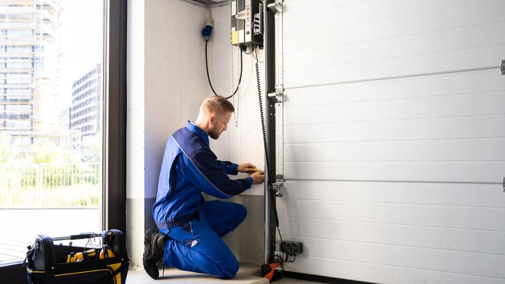 technician installing garage door system as part of home upgrades that add value before selling