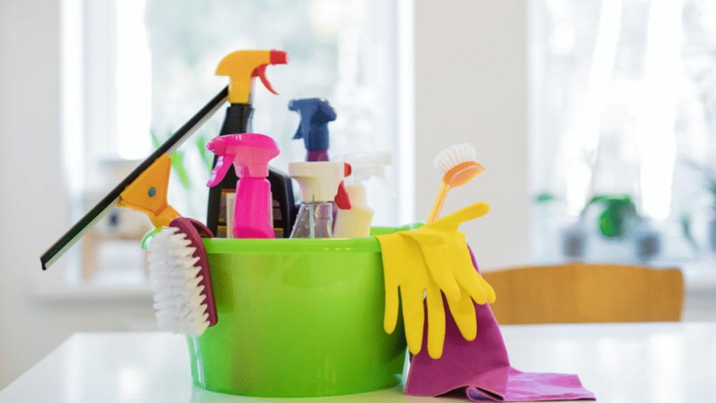 cleaning tools and products in a bucket used for home cleaning before staging and listing