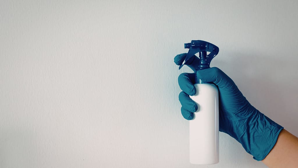 spraying and cleaning walls during deep cleaning a house