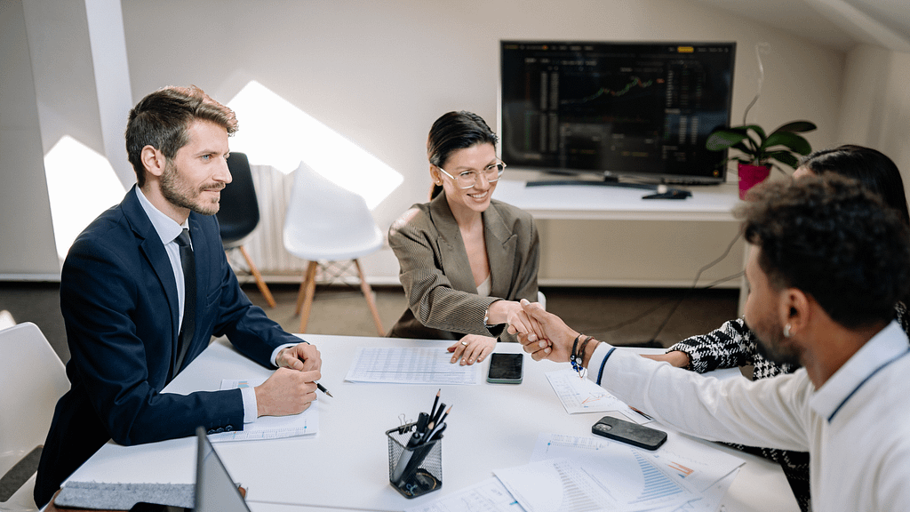 best real estate agents meeting clients and finalizing agreement with handshake