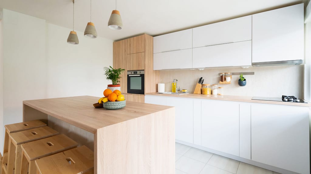 Modern white and wood kitchen with island showing how to upgrade a kitchen on a budget with simple design updates