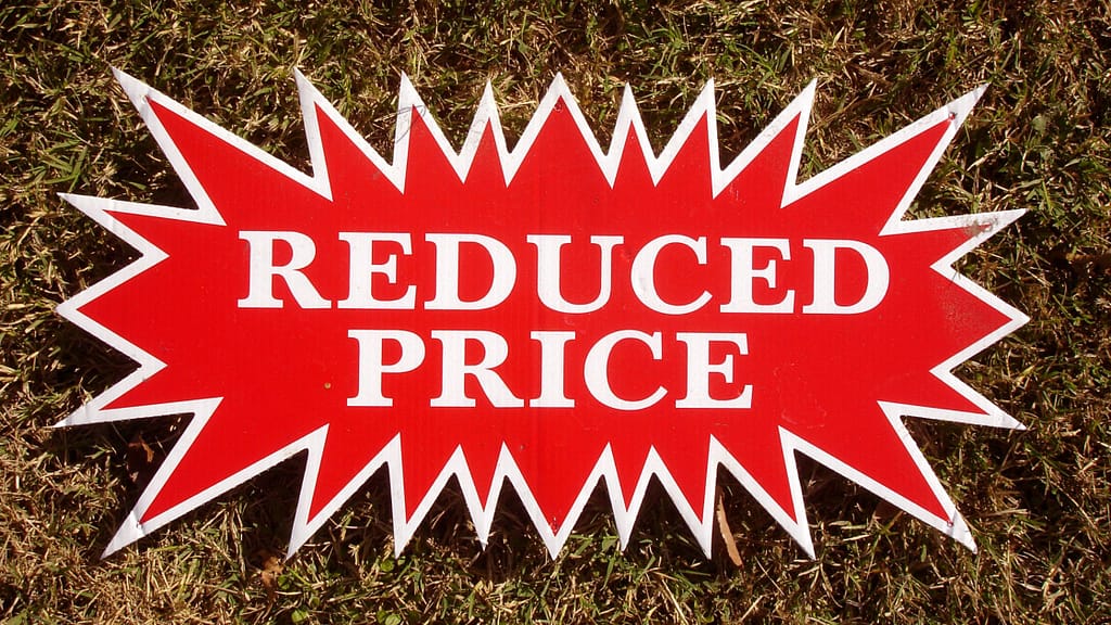 Reduced price sign showing the risks of poor pricing when choosing a listing agent