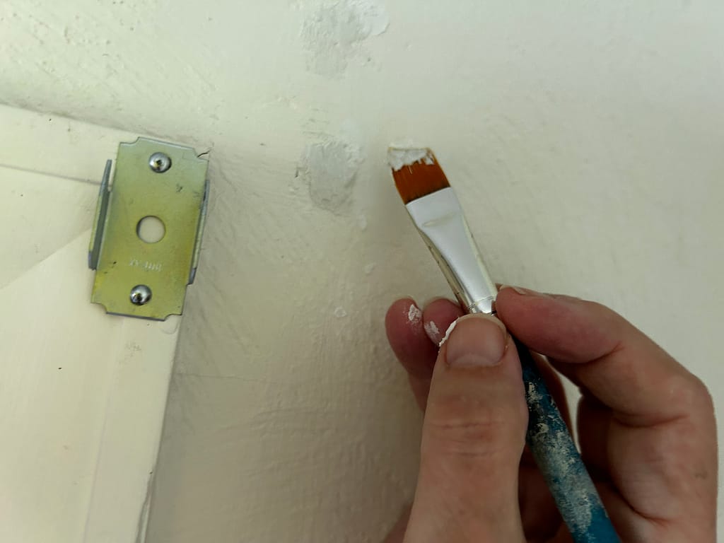 Applying paint over wall filler as part of preparing walls for painting