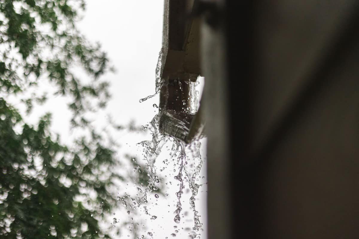 Overflowing gutter needing fall home maintenance