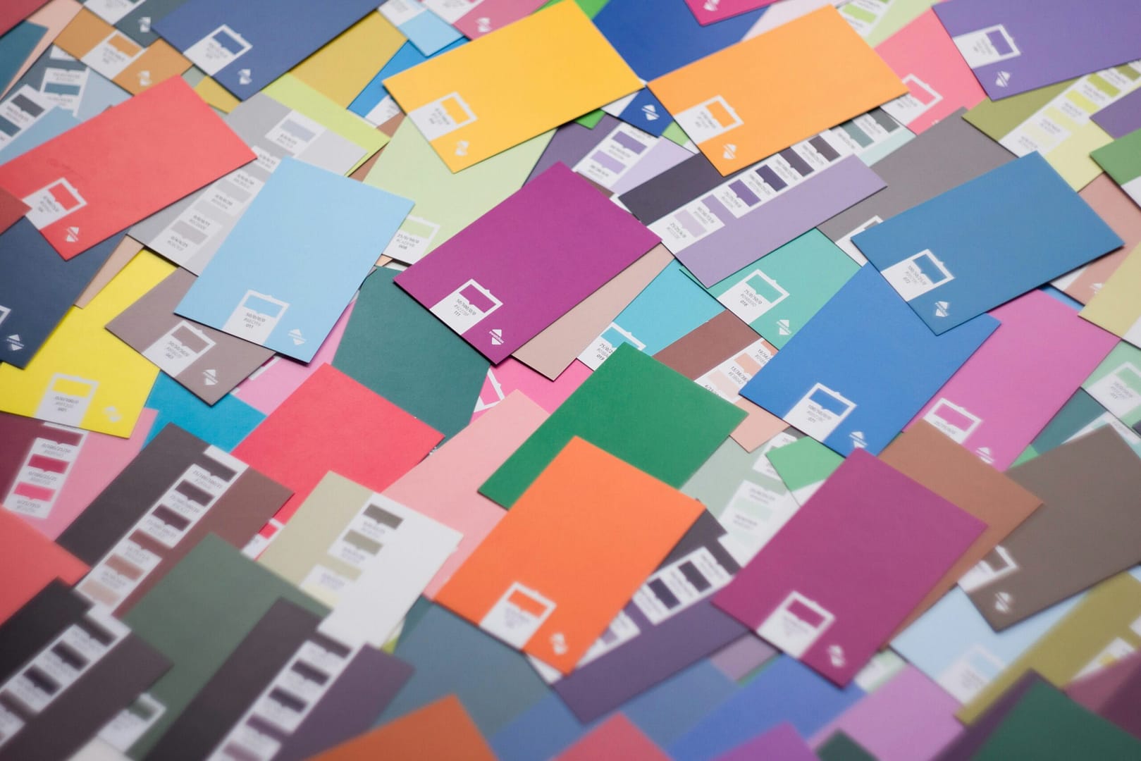 Assorted paint and color sample cards showing variation, selection, and palette decision-making in design. color palette selection, design color samples, color decision making, spatial design palette, interior color planning