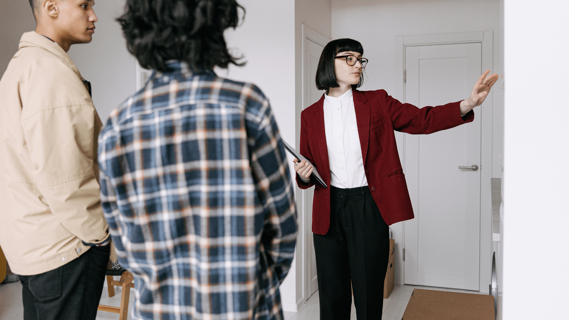 Real estate agent showing a home to buyers during a property tour