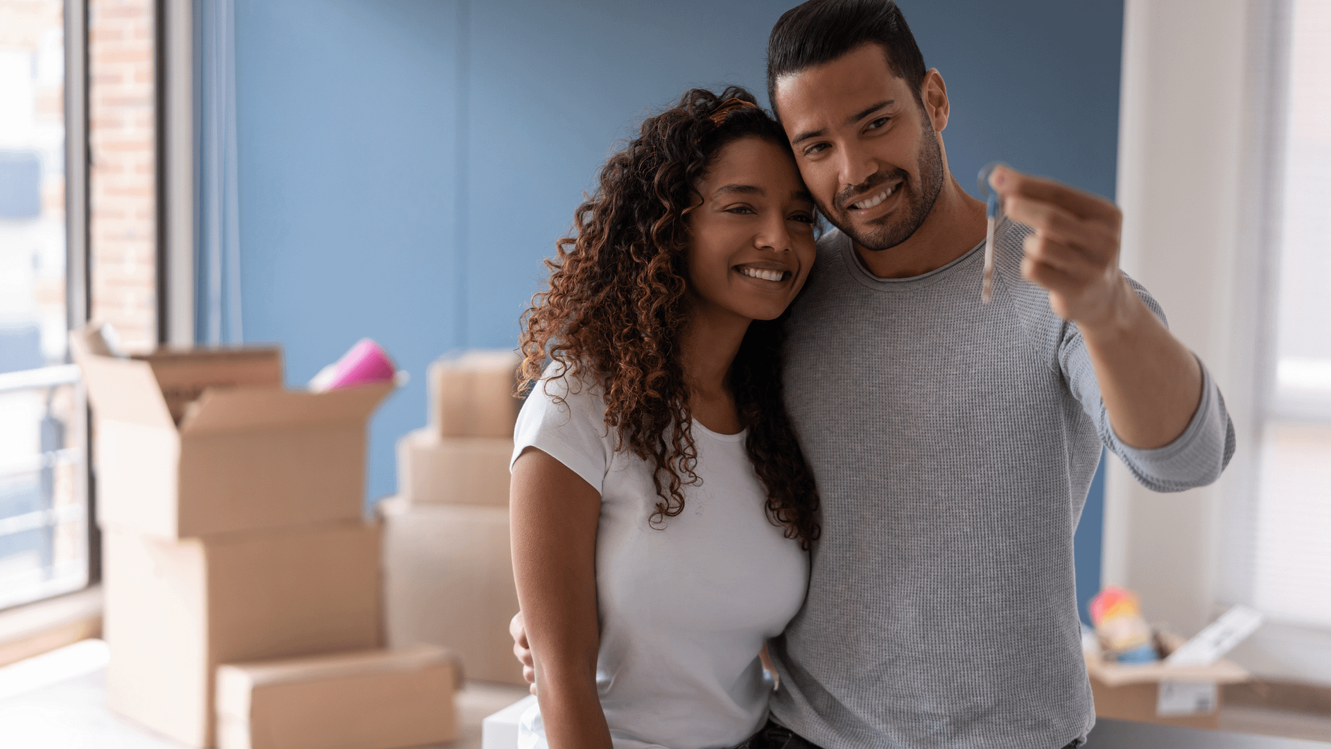 Young couple choosing the best time of the year to buy a house