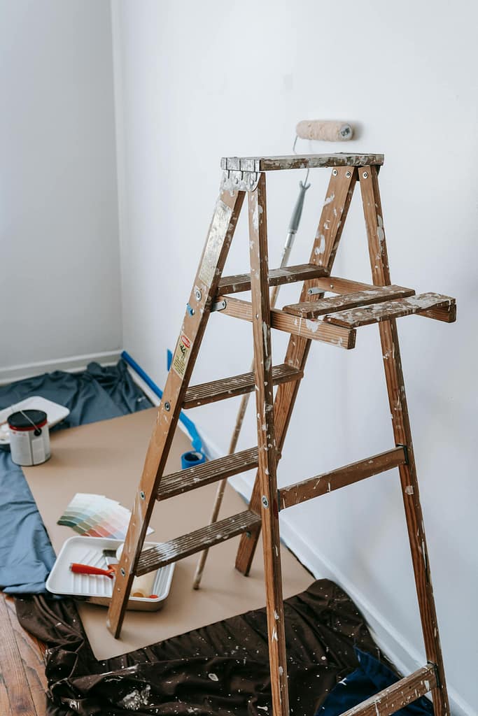 how to paint a room setup with ladder roller and painting tools