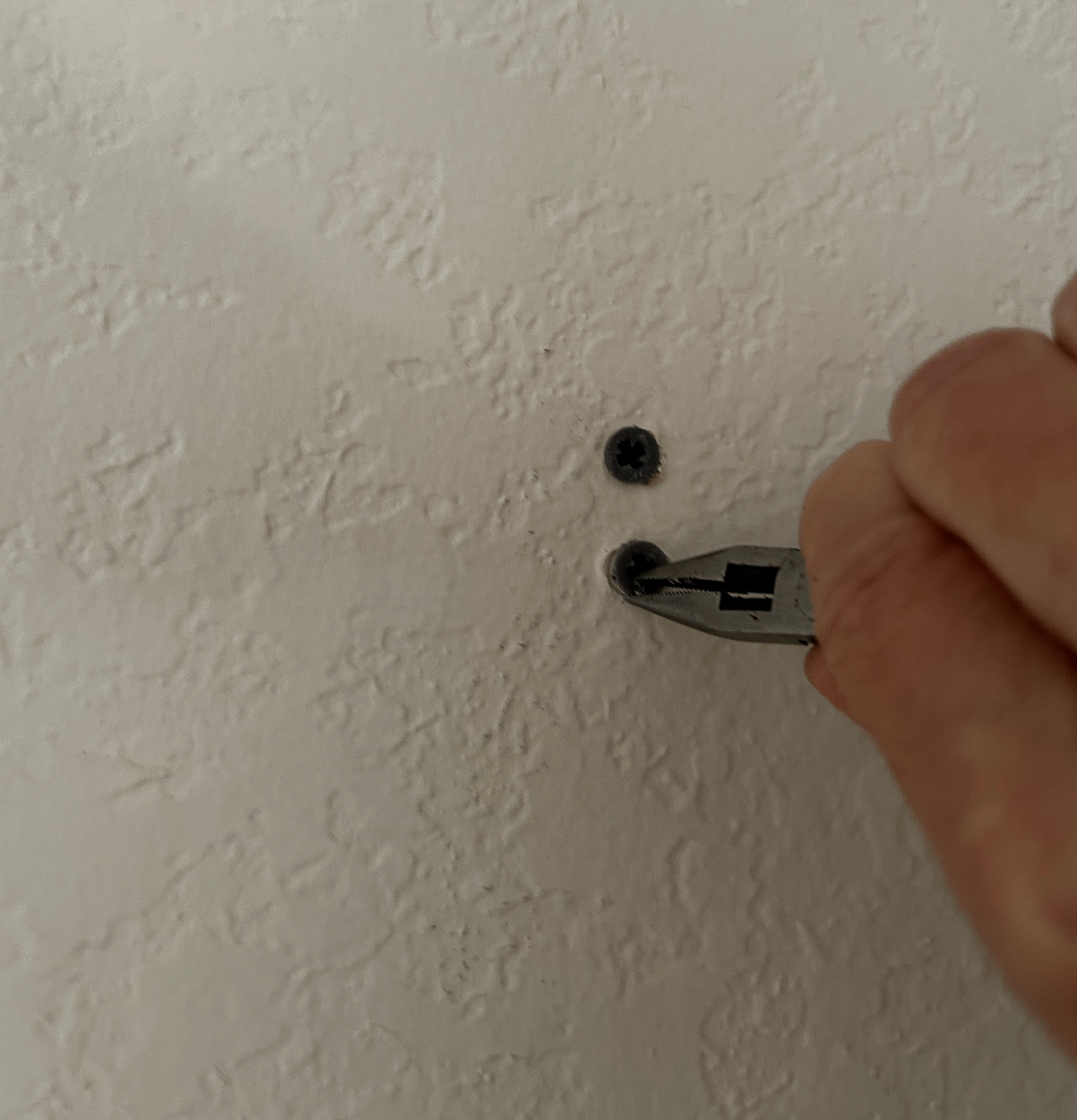 Removing screws from wall before repairing and preparing walls for painting